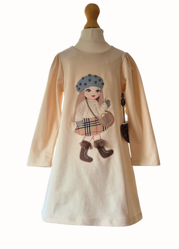 Cream dress with a large doll motif in the centre with hat, sparkle top, checked skirt and fringed boots on a white background.