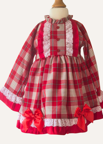 Spanish red, beige and white plaid dress with lace details and red bows on a mannequin.
