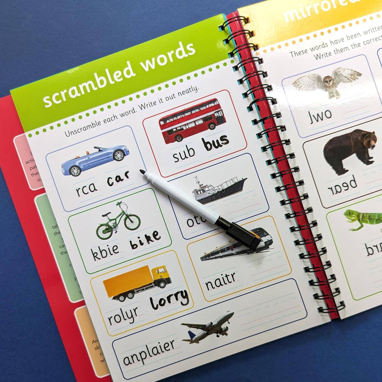 Open educational book with scrambled words and pictures on a blue background