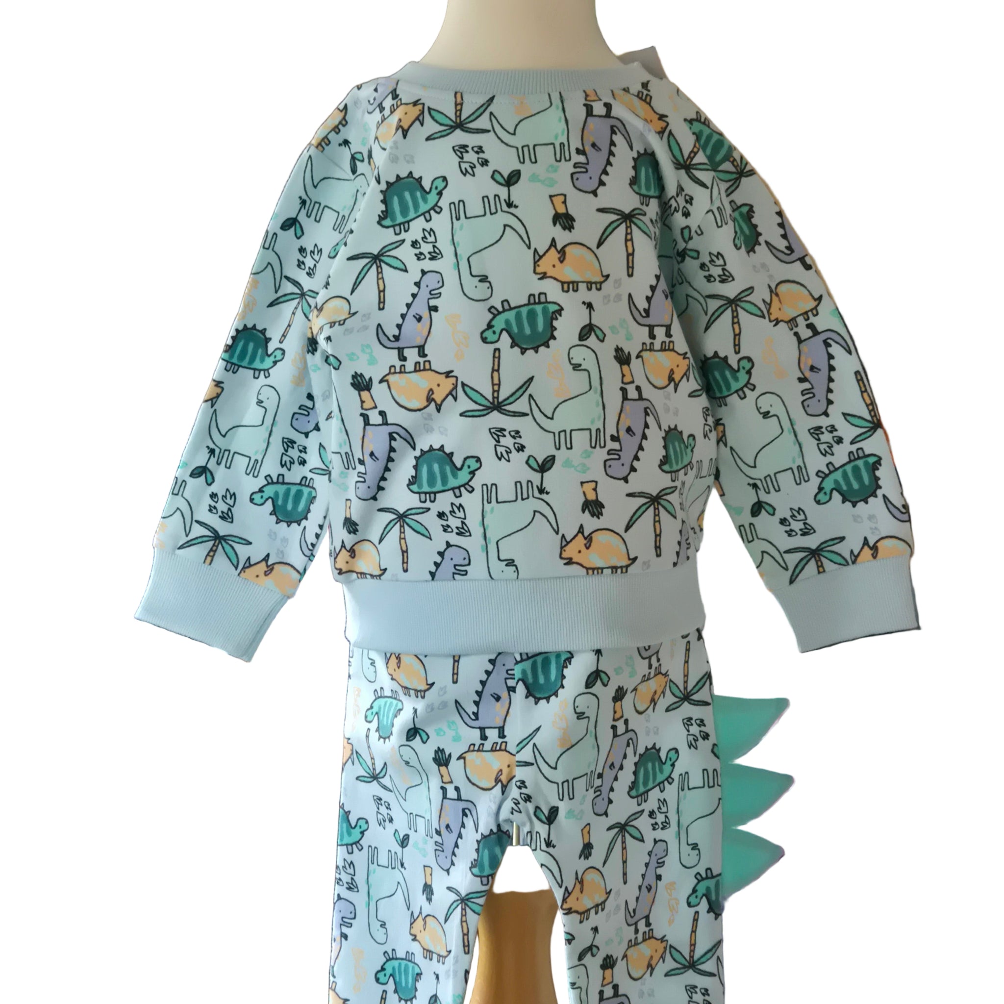 Children's outfit with dinosaur pattern on a mannequin against a white background