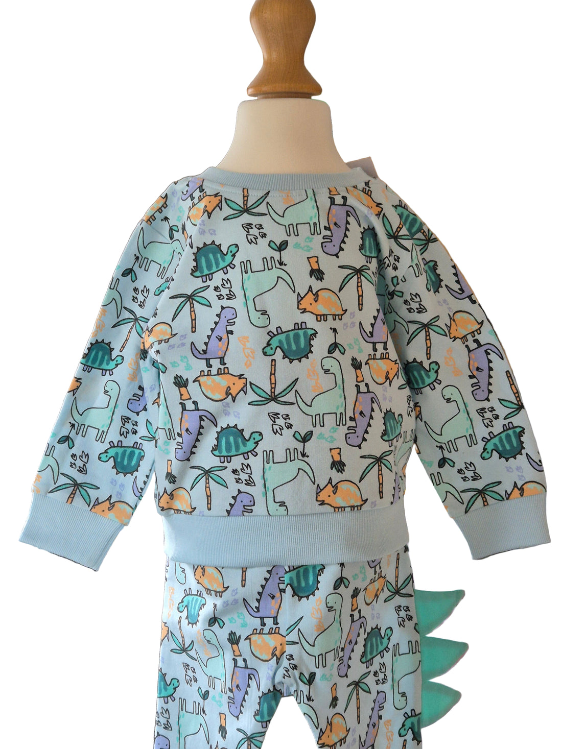 Children's outfit with dinosaur pattern on a mannequin against a white background