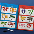 Educational book with number recognition activities on a blue background