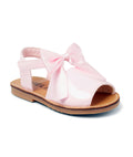 Pink sandal with a bow on a white background