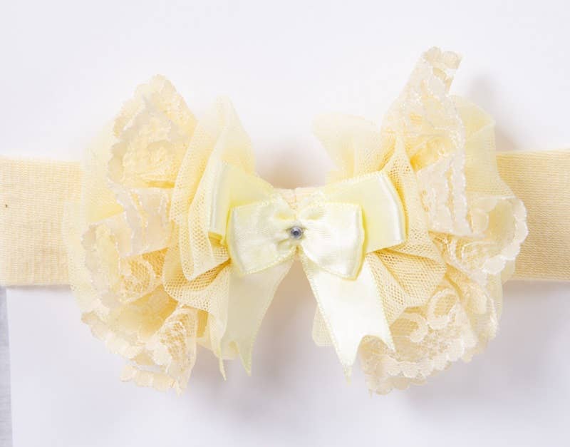 Yellow lace headband with a bow on a white background