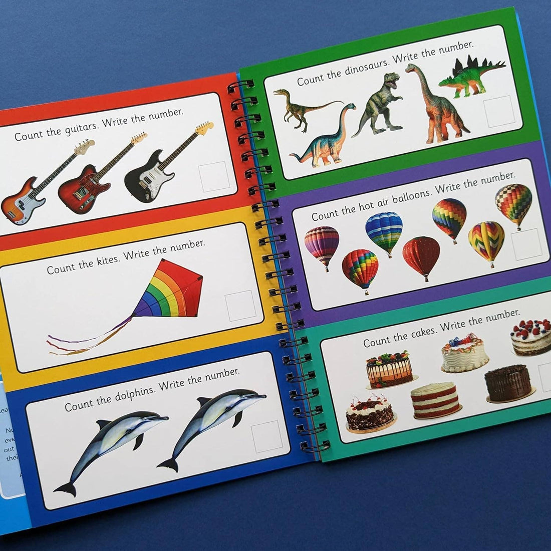 Children's educational book on numbers with colorful illustrations and a pen for activities.