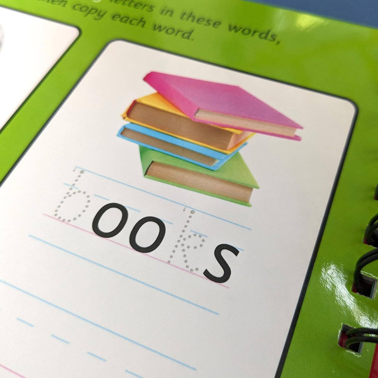 Educational book with colorful books illustration and dotted letters for the word 'BOOKS'.