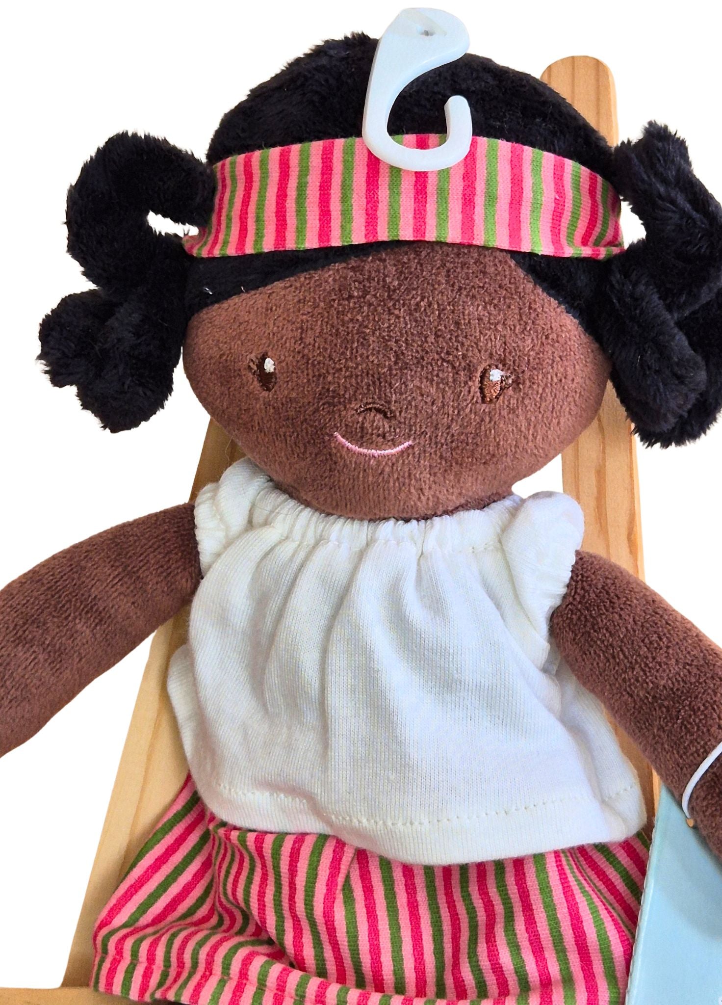 Black rag doll with braids and stripy outfit