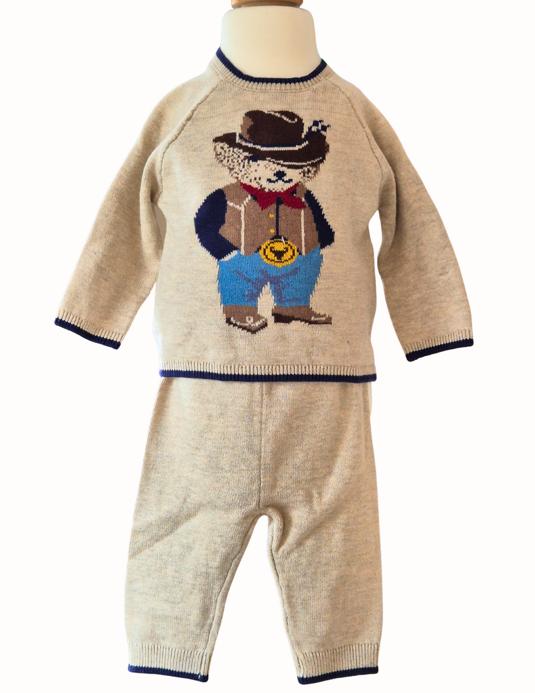 Knitted jumper with a cowboy bear design and matching trousers on a white background