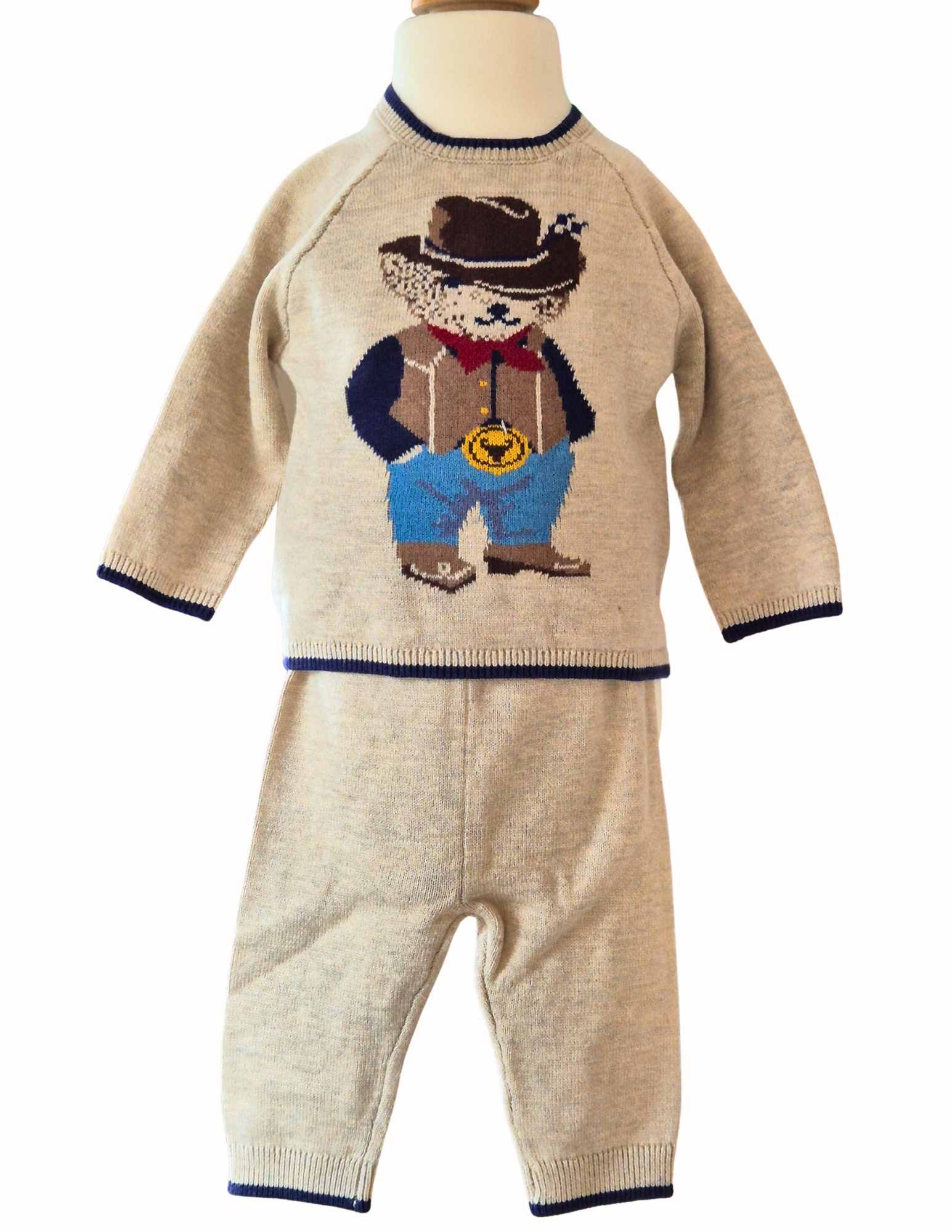 Knitted jumper with a cowboy bear design and matching trousers on a white background