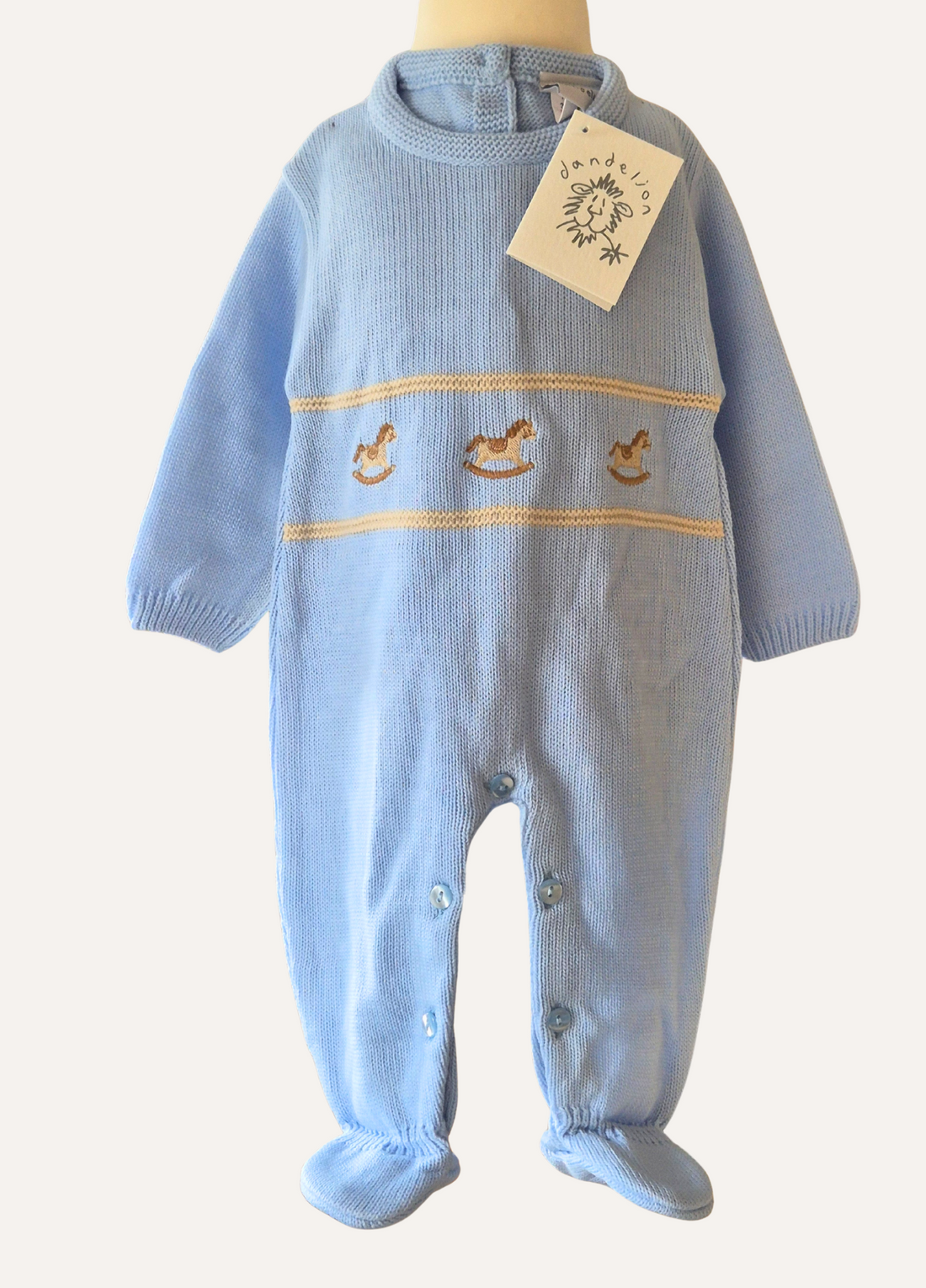 Baby blue knitted romper from Dandelion with rocking horse motif