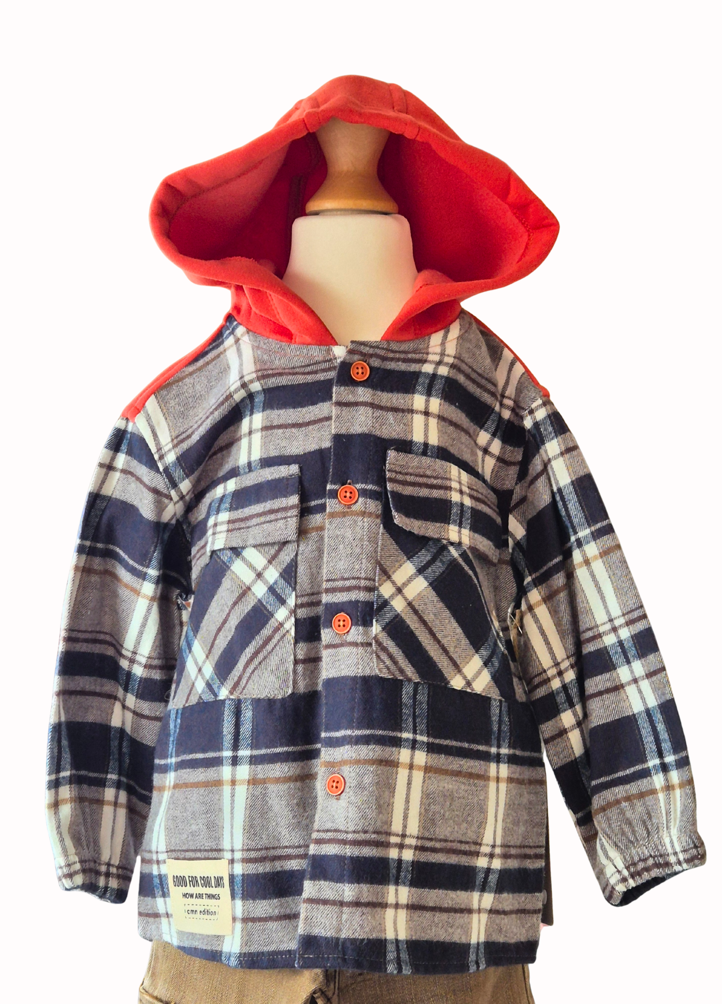Plaid shirt with orange hood on a mannequin against a white background