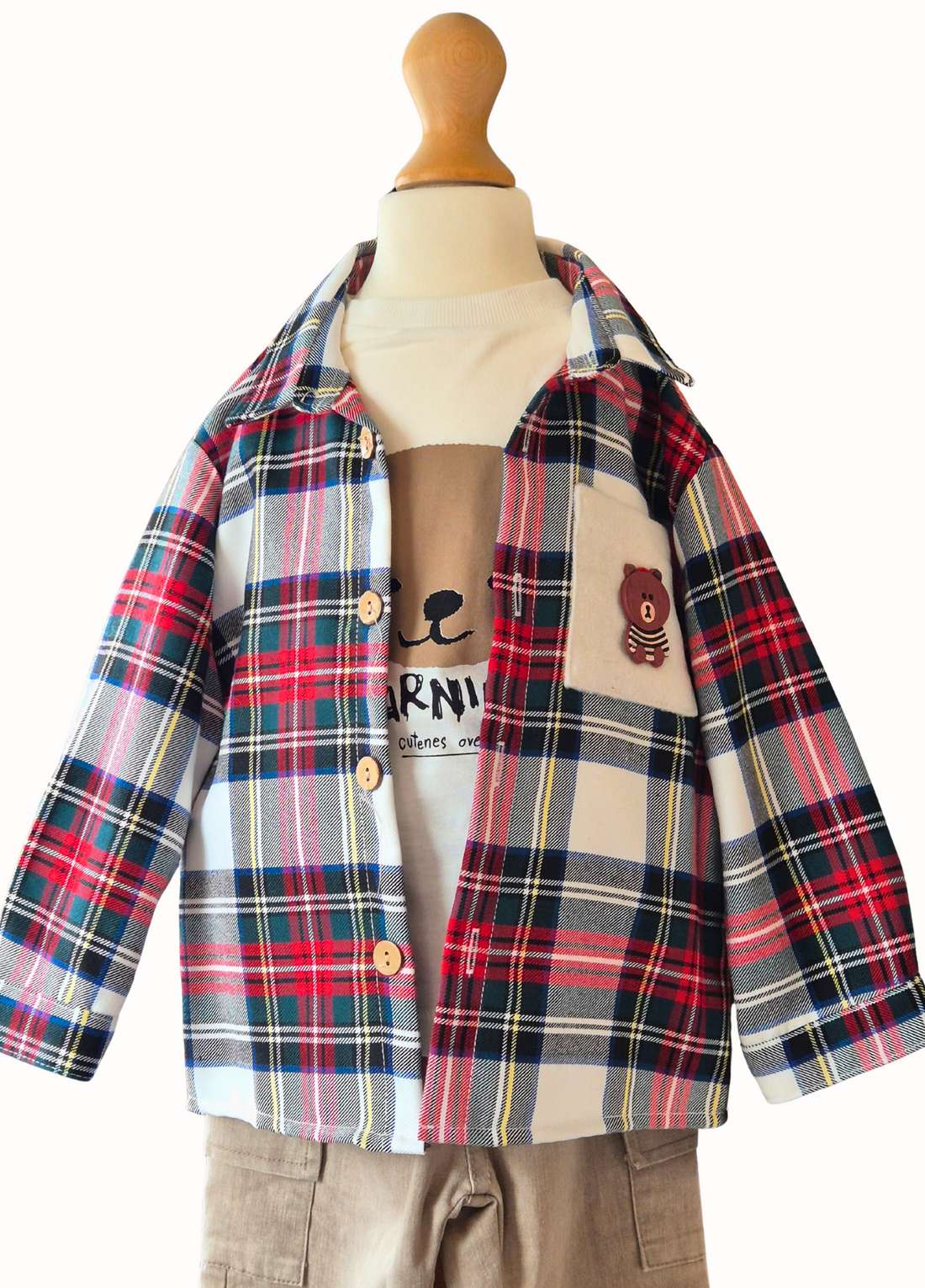 Plaid shirt and beige pants on a mannequin with a white background