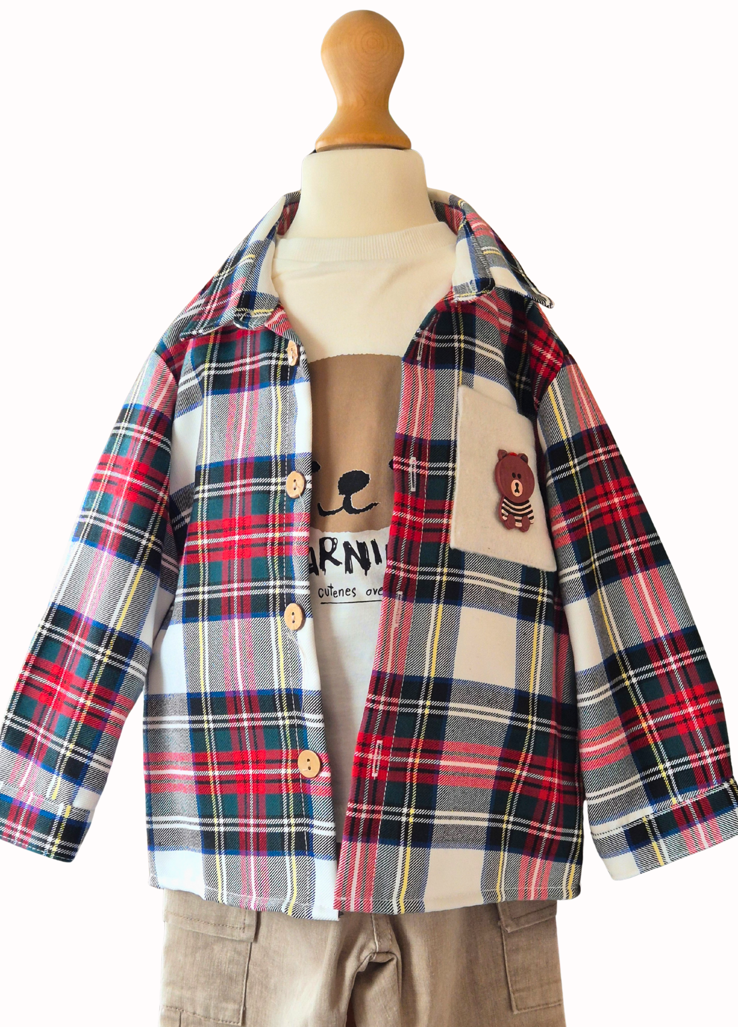 Plaid shirt over a white long sleeved top with visible branding on a mannequin against a white background