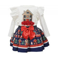 White top featuring a gingerbread house and a blue, red and white skirt with houses trees, snowmen and a christmas train around it.