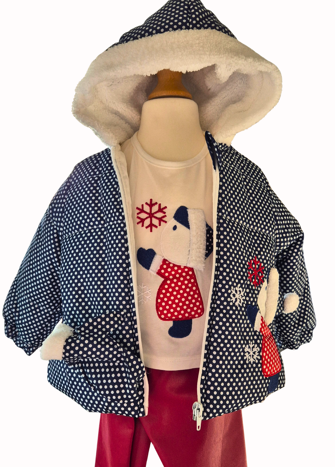Children's outfit with a patterned jacket and red pants on a mannequin against a white background