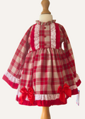 Spanish red and beige plaid dress with ruffles and bows.background