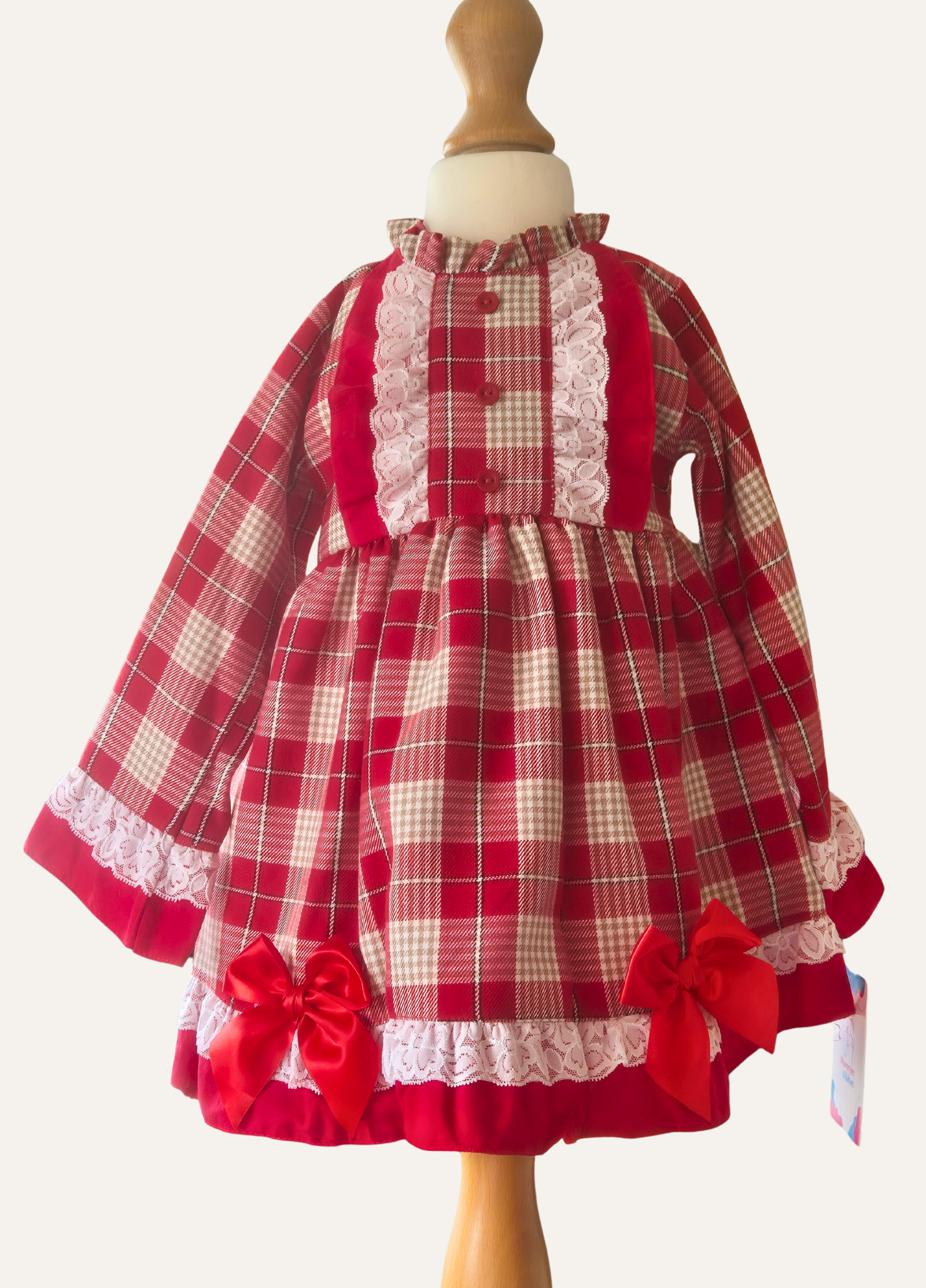 Spanish red and beige plaid dress with ruffles and bows.background