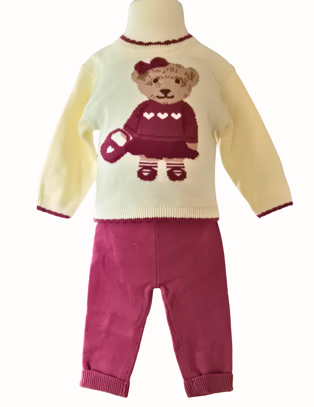 Kniited 2 piece set with girl jumper and trousers on a white background