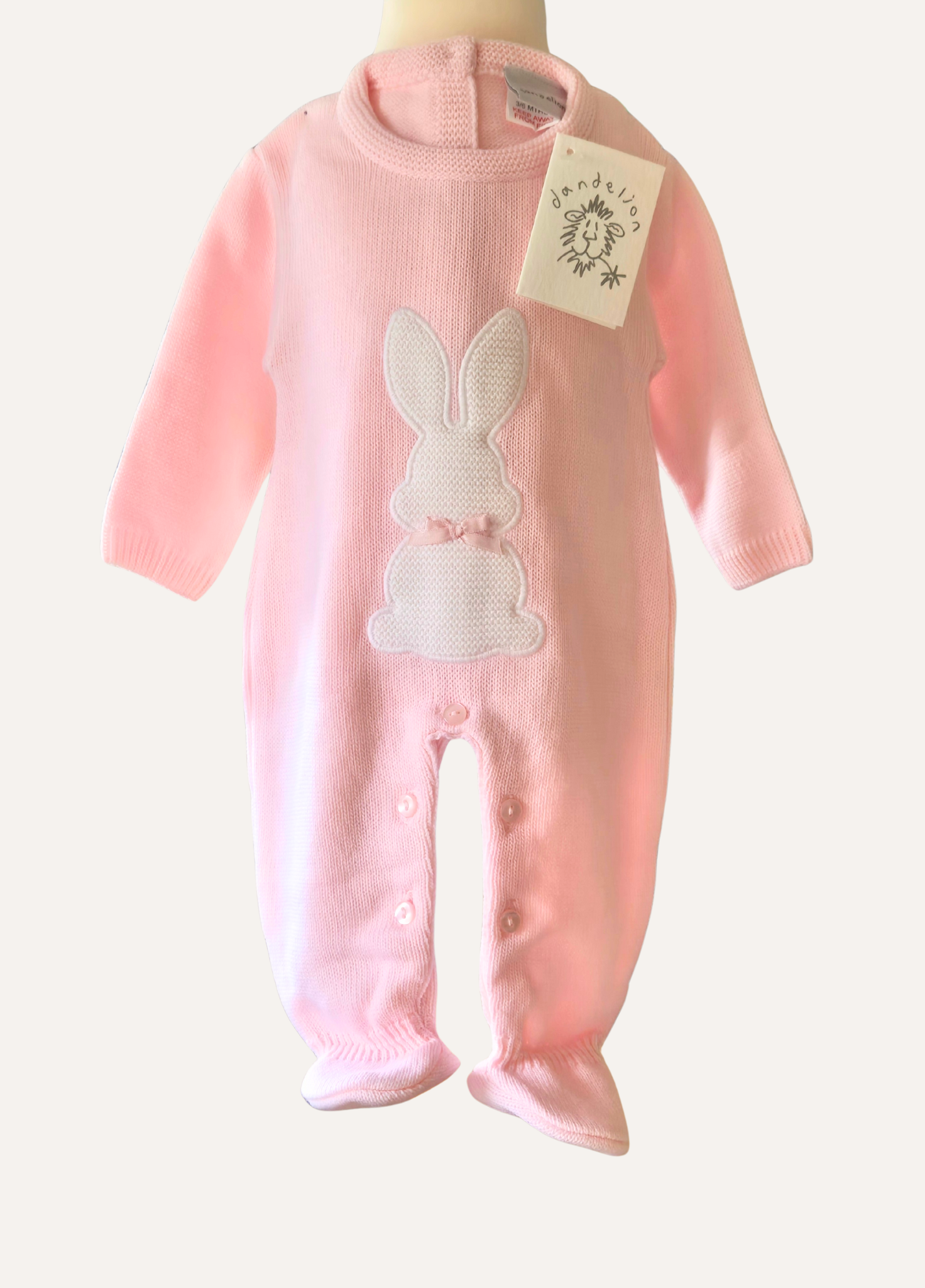 Baby pink knitted onesie from Dandelion with White rabbit detail
