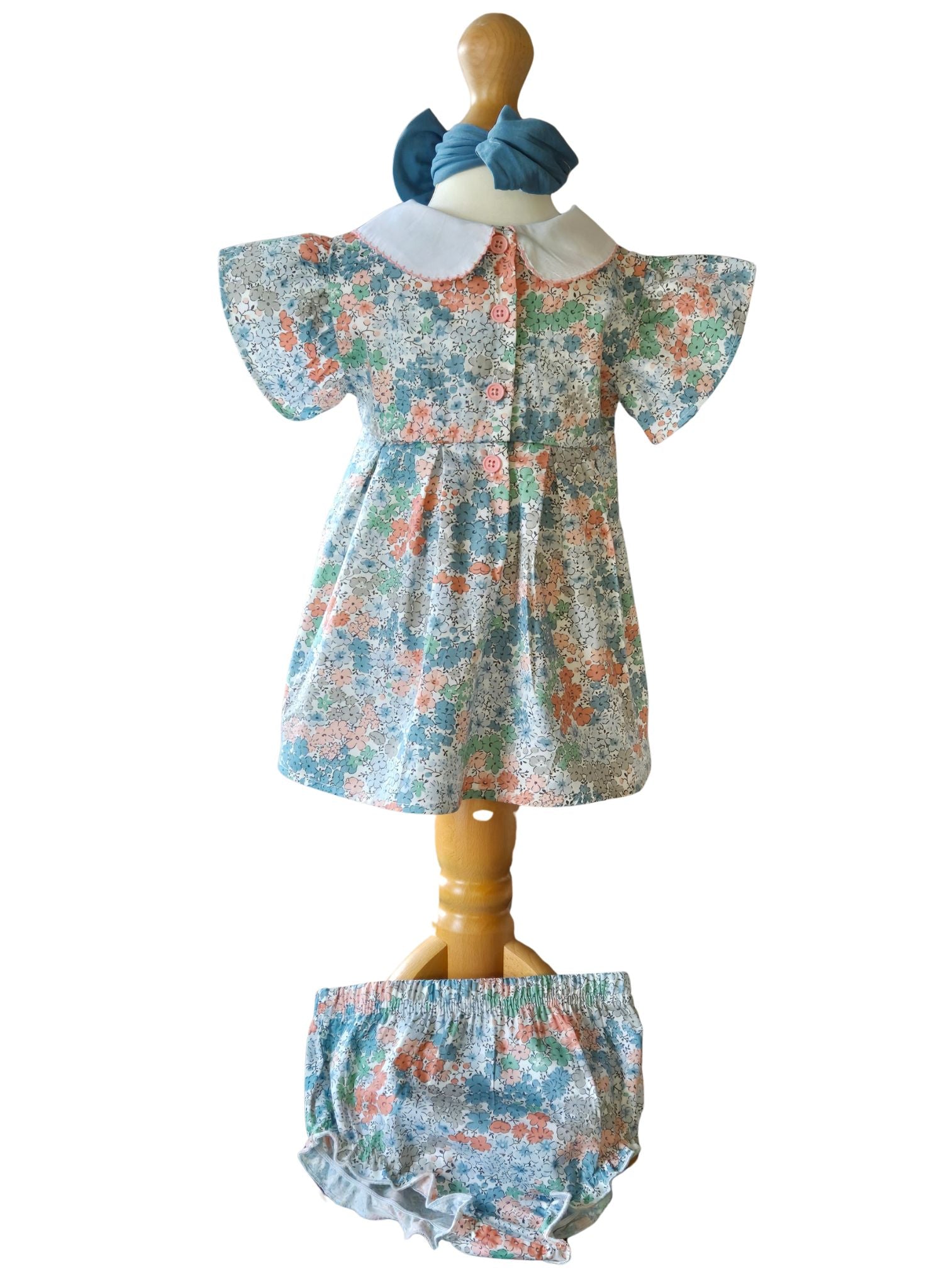 back of a baby girl floral occasion dress with peter pan collar