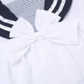 Close-up of ababy girls navy sailor summer dress