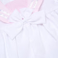 Close-up of a white and pink sailor dress from Rock A Bye Baby