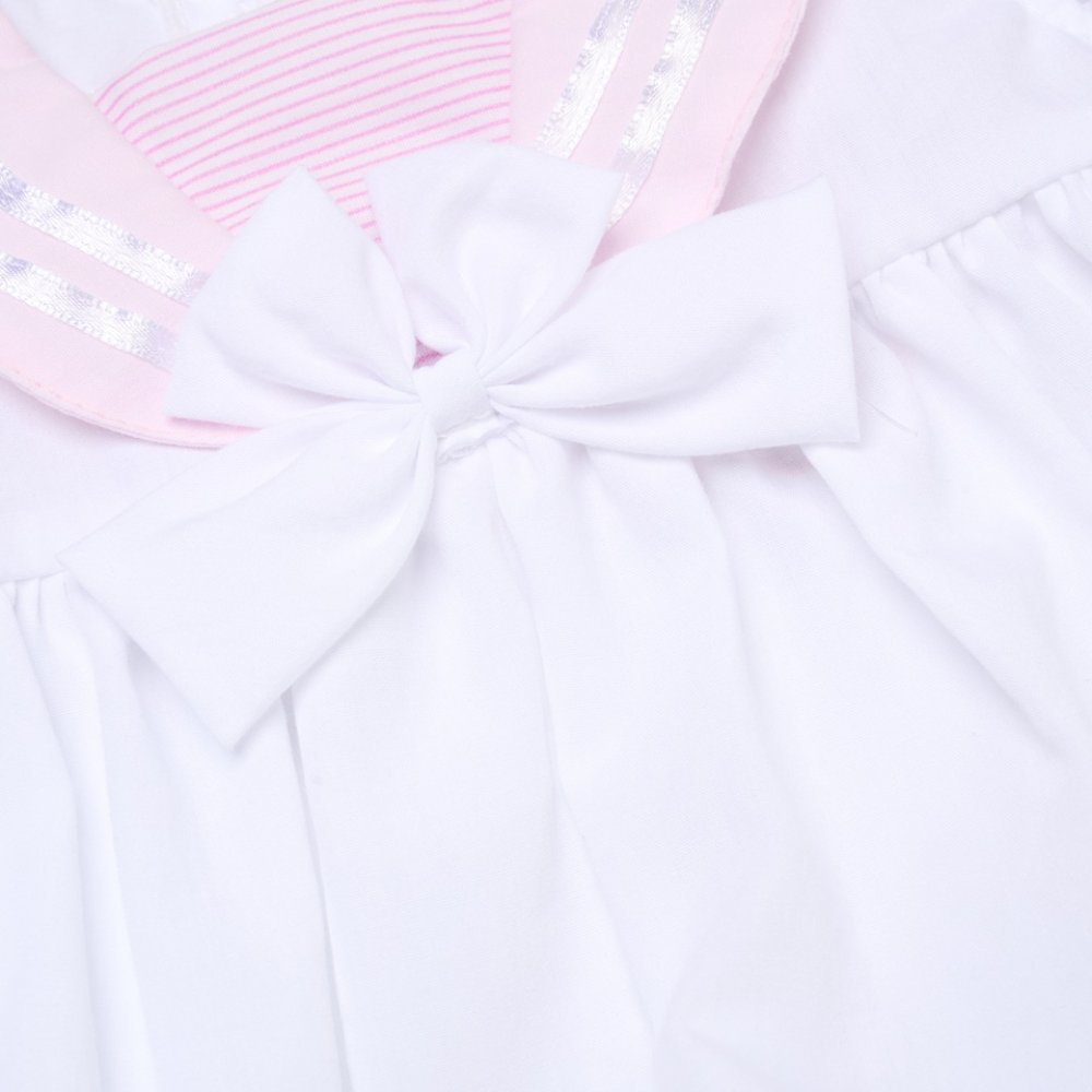 Close-up of a white and pink sailor dress from Rock A Bye Baby