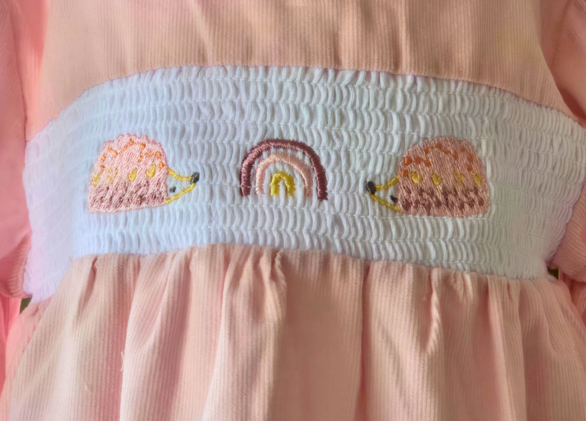 Smocked detail of rainbow and hedgehog on girls pink 3 piece dress set