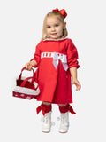Child wearing Spanish red dress with lace collar and a white bow