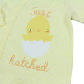 Baby romper with chick design and 'Just hatched' text on a lemon background