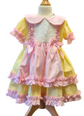 Pastel-colored dress with ruffles on a mannequin against a white background