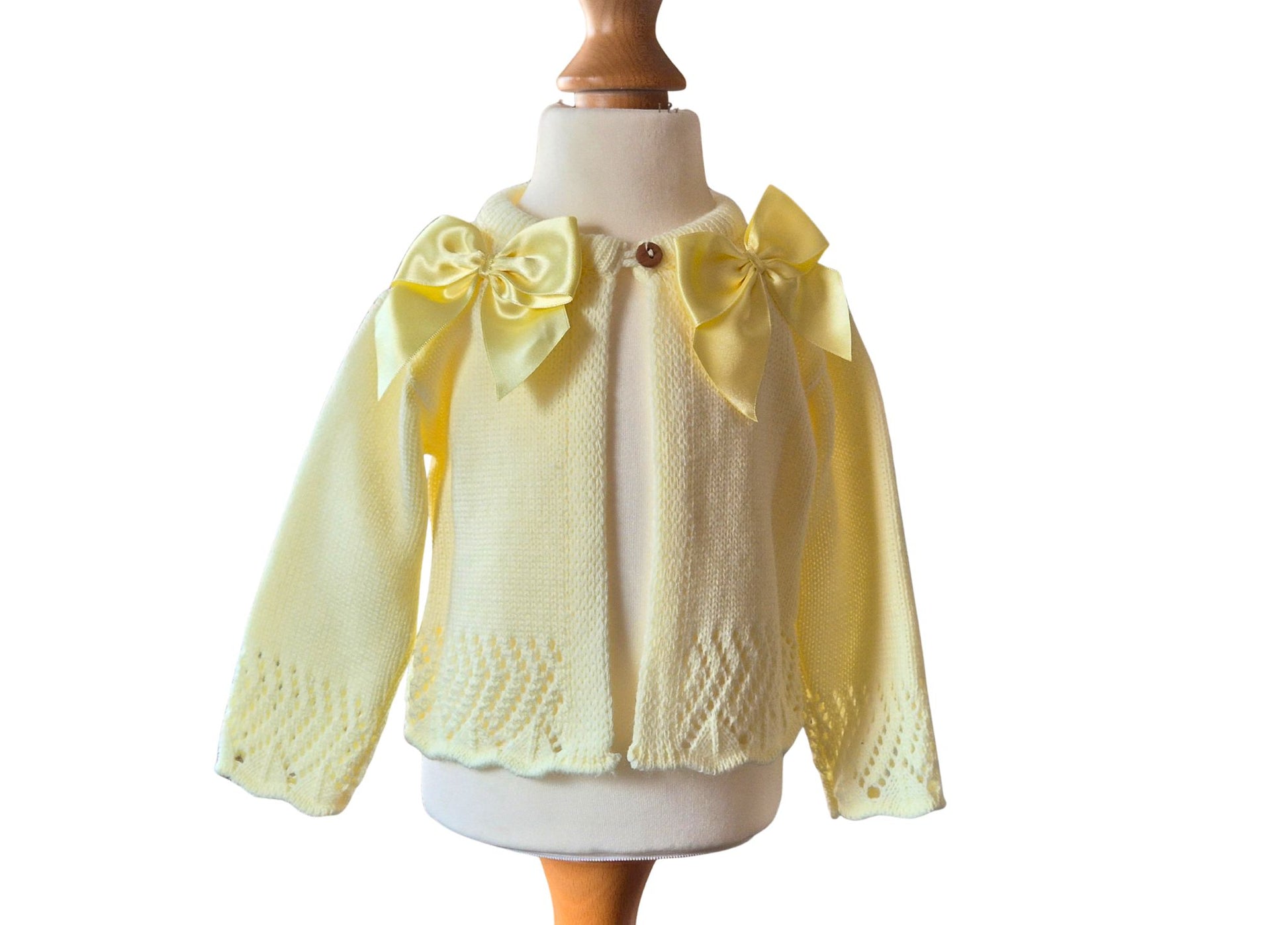 Lemon knitted cardigan with double satin  bow details on a mannequin against a white background