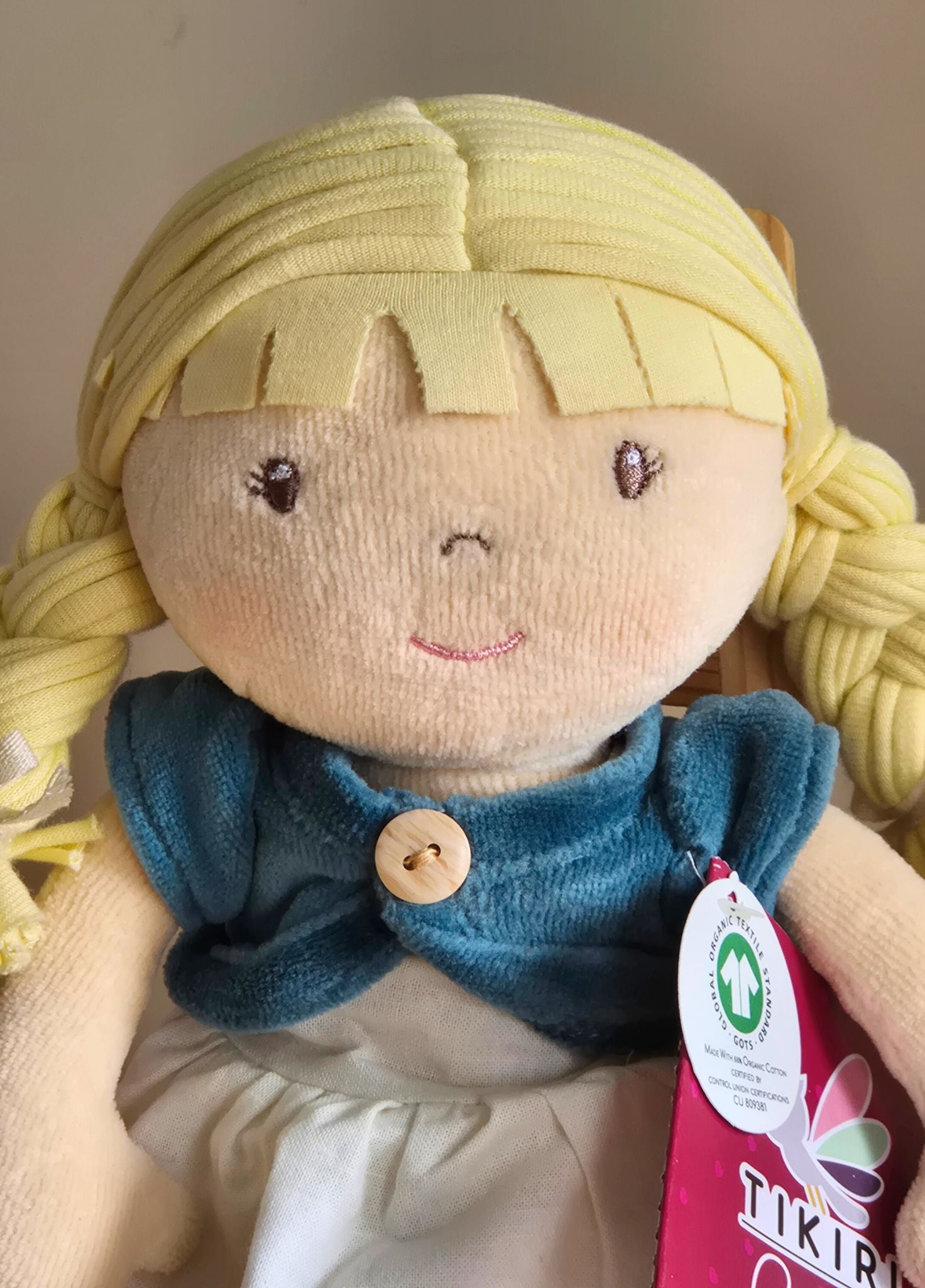 Organic  ragdoll with blonde hair and blue clothing, wearing a Tikiri tag.