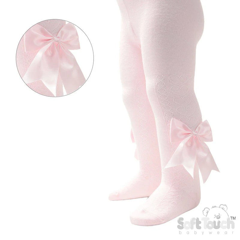 Pink tights with large bows and heart design on a white background, featuring the Soft Touch brand.