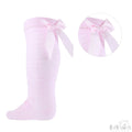 Pink knee-high socks with a bow detail on a white background