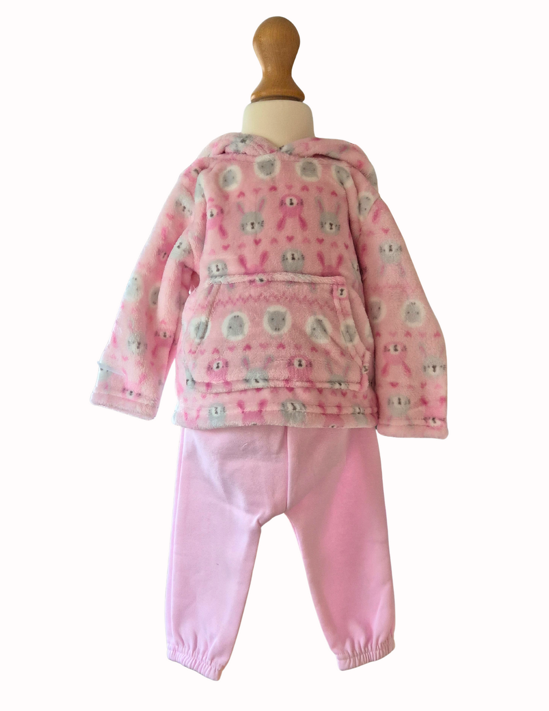 Pink children's outfit with patterned top and solid pants on a mannequin against a white background