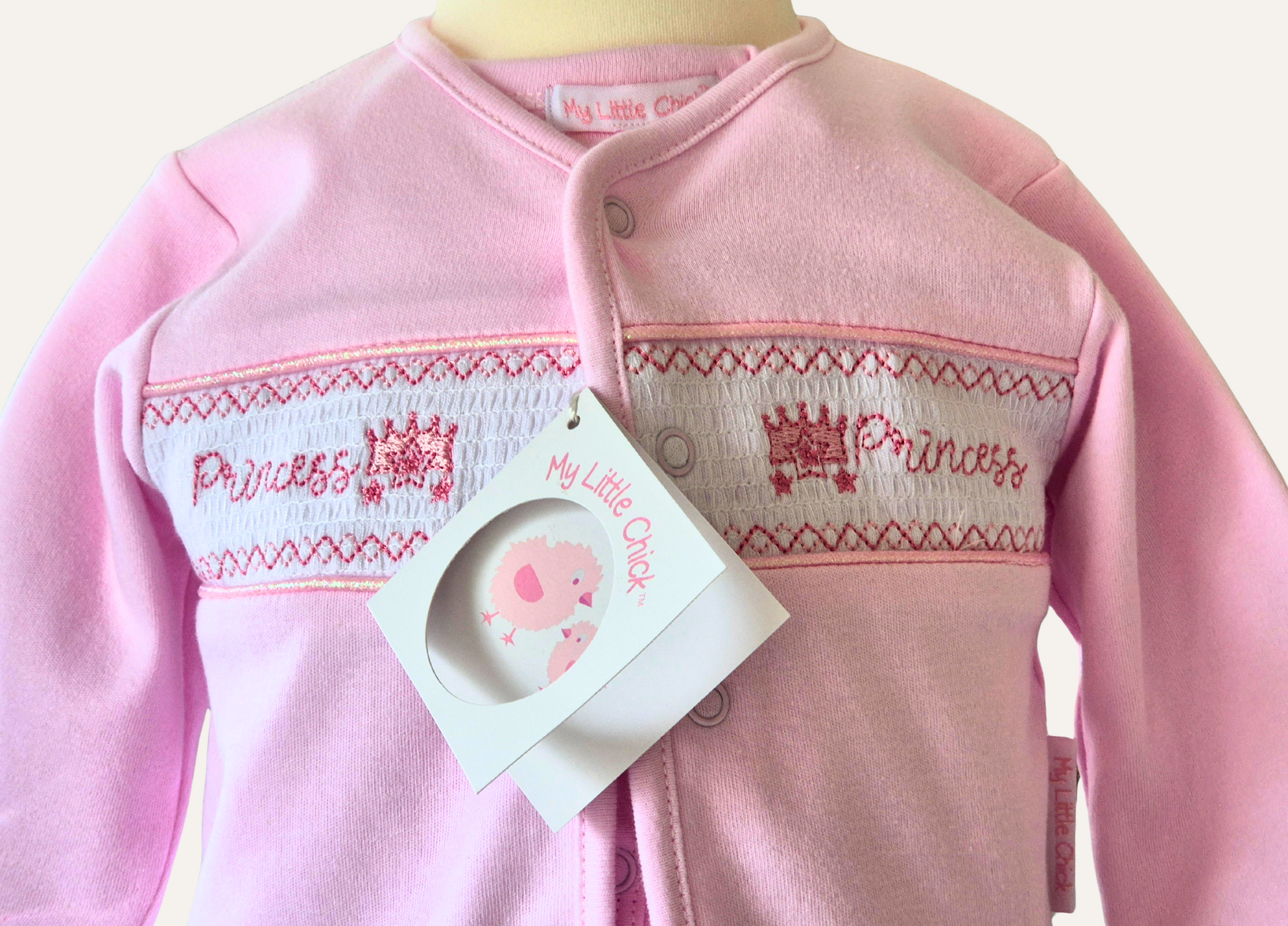 Close up of smocked area of the pink Princess baby jacket by My Little Chick