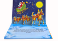 Pop-up Christmas book with Santa Claus and reindeer sleigh against a starry night sky.