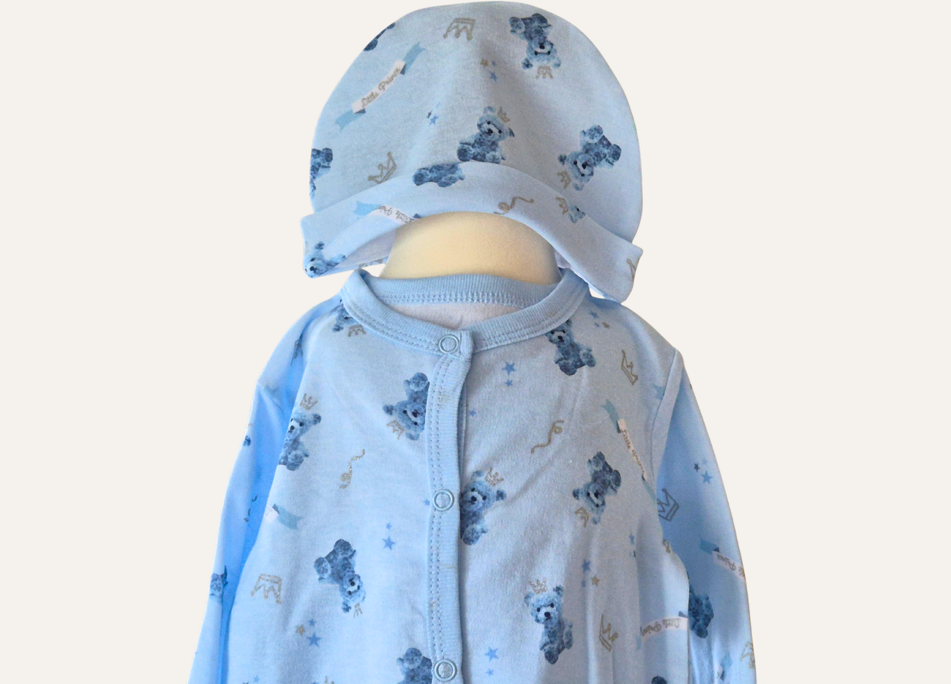 Close up of the blue Baby boys Teddy Prince romper and hat print from Rock A Bye Baby