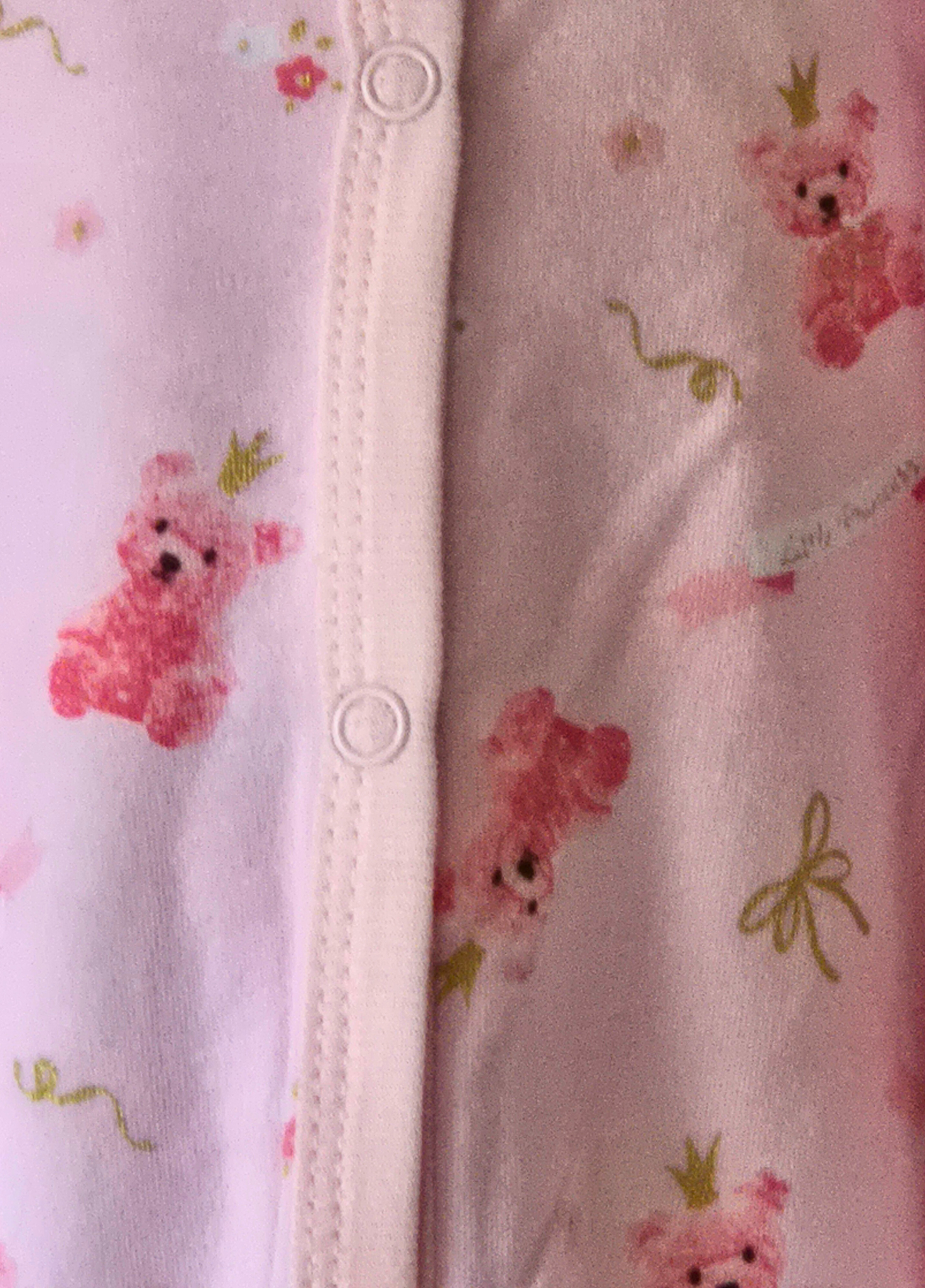 Close up of the baby girls pink teddy princess fabric from the 5 piece set