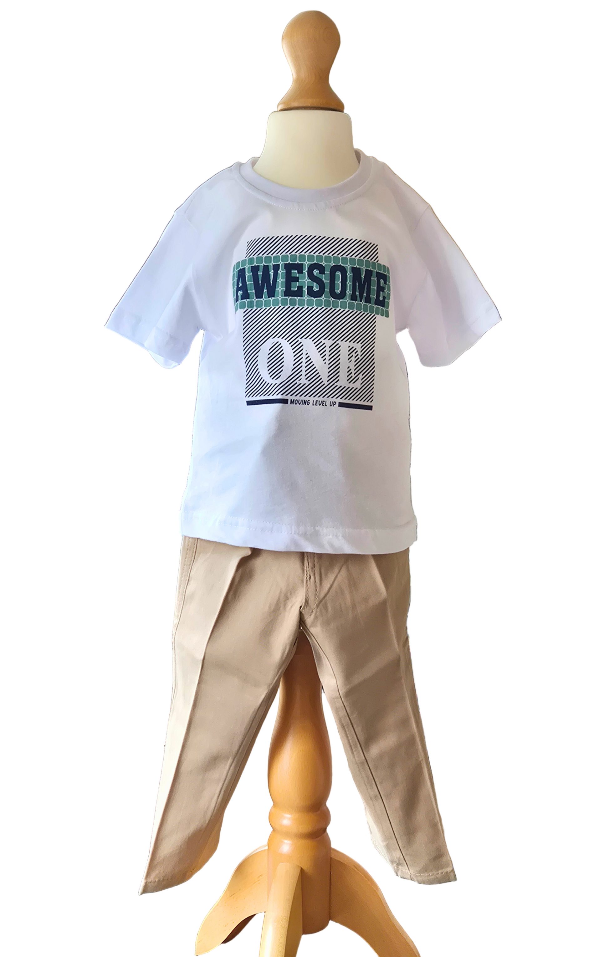 Child's outfit with a white t-shirt and beige pants on a mannequin with a white background
