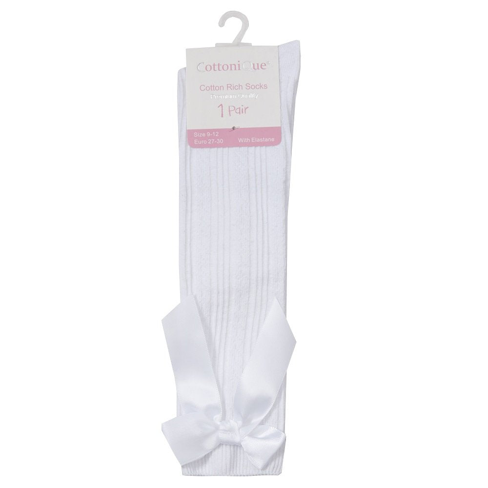 White cable knee-high sock with a bow on a white background