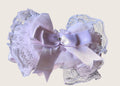 Babys headband with Decorative lace bow with a central ribbon on a light background