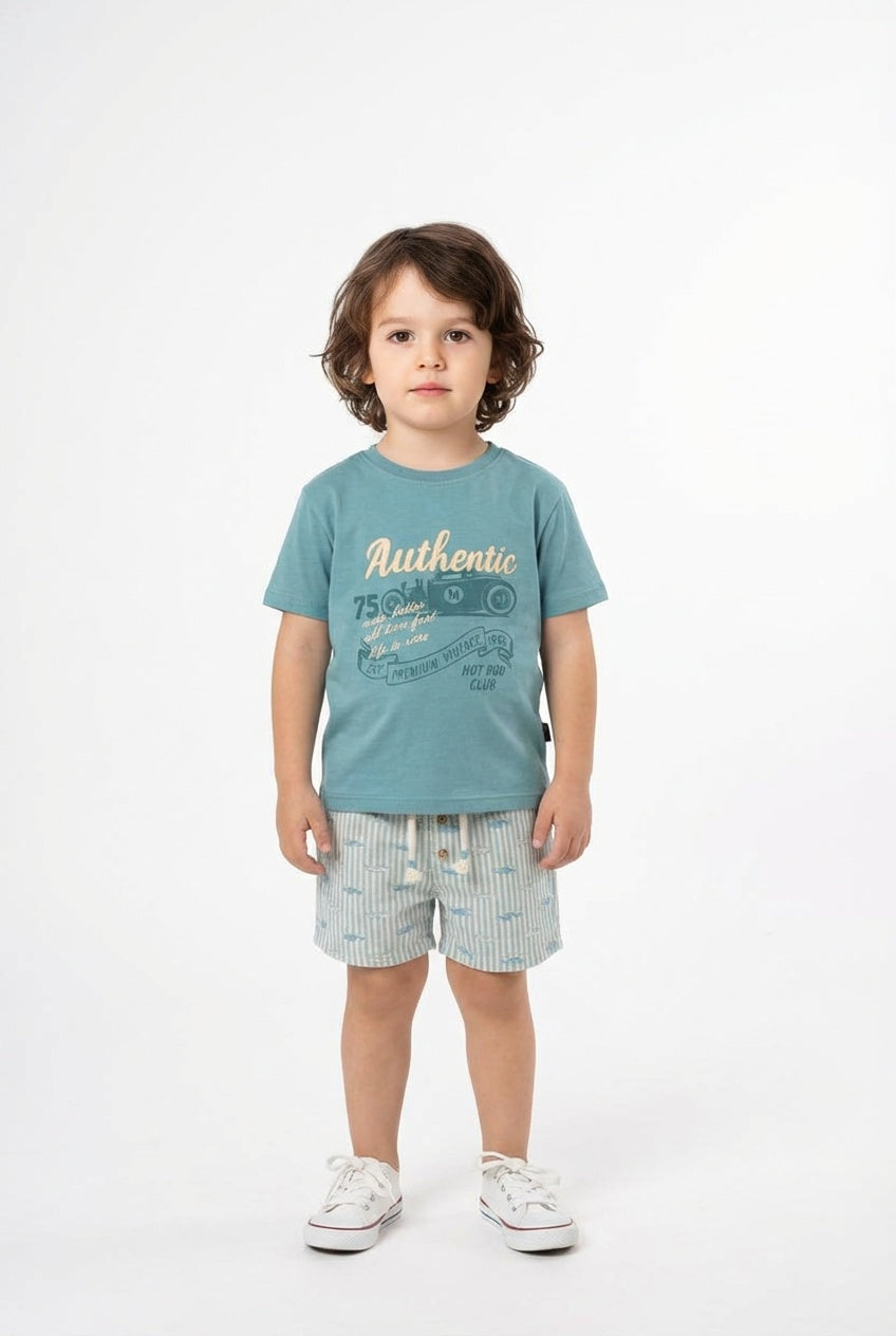 Child wearing a blue t-shirt with text and shorts on a white background