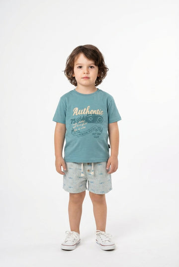 Child wearing a blue t-shirt with text and shorts on a white background