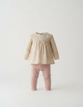 Beige floral Spanish baby top with pink perforated leggings
