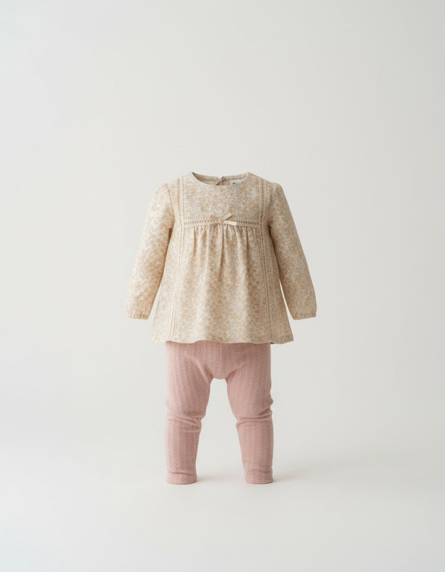 Beige floral Spanish baby top with pink perforated leggings