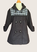 Black coat with plaid collar on a mannequin against a beige background