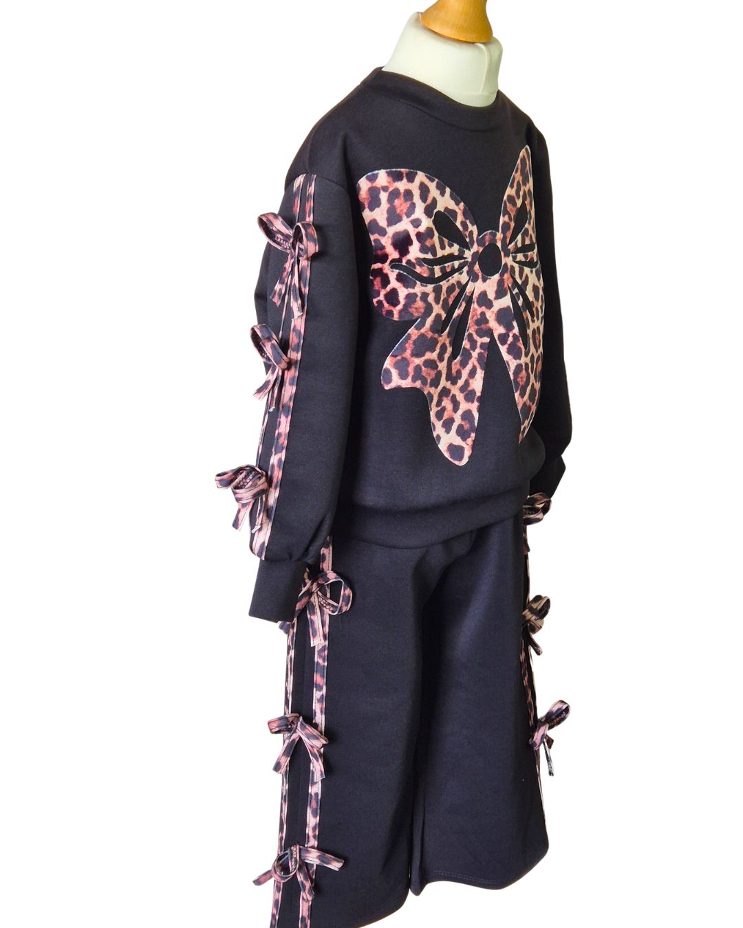 Girls black leisure suit with statement animal print bow