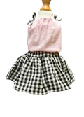 Pink top and black and white checkered skirt on a mannequin against a white background